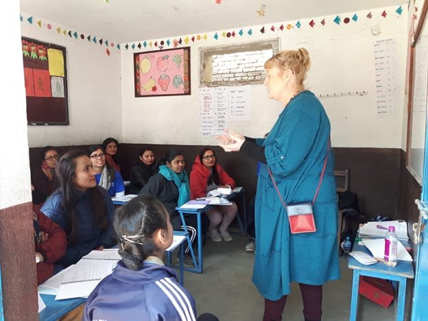 Course leader giving lesson to local participants in conference room