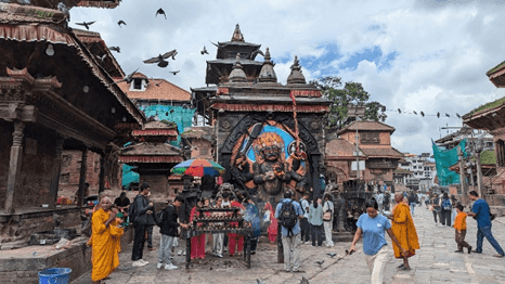 Devotees engaged in religious practices in front of a representation of the god Shiva.